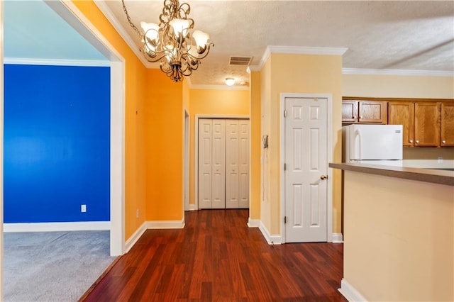 99 Rainwater Ln, Dallas, GA 30157 - unfurnished dining area featuring a chandelier, dark wood-style floors, baseboards, ornamental molding, and a textured ceiling