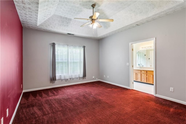 99 Rainwater Ln, Dallas, GA 30157 - carpeted empty room with a ceiling fan, a textured ceiling, baseboards, a sink, and a tray ceiling