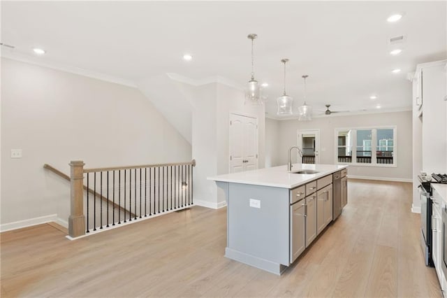 1987 Deco Dr, Kennesaw, GA 30144 - kitchen featuring gray cabinets, crown molding, ceiling fan, recessed lighting, and an island with sink