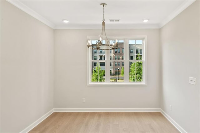 1987 Deco Dr, Kennesaw, GA 30144 - unfurnished dining area featuring a chandelier, crown molding, and light wood-style flooring
