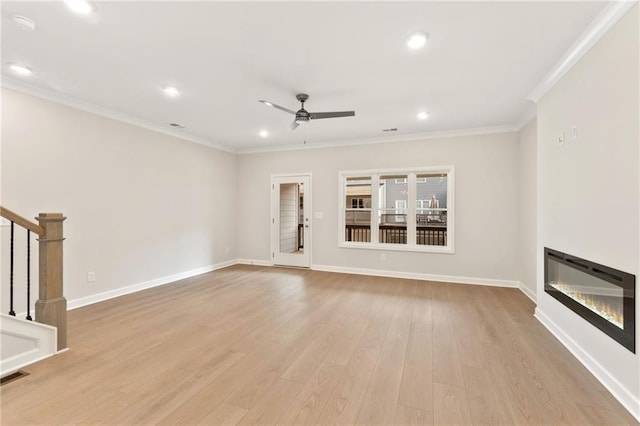 1987 Deco Dr, Kennesaw, GA 30144 - unfurnished living room with crown molding, a ceiling fan, light wood-style floors, recessed lighting, and a glass covered fireplace