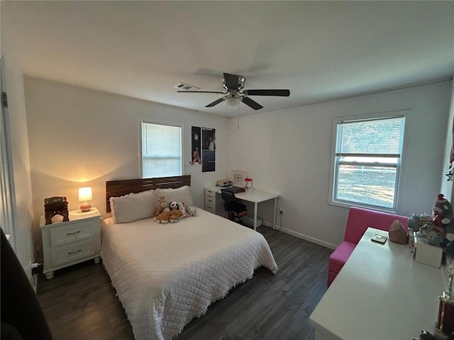 bedroom featuring dark wood-style floors, baseboards, visible vents, and a ceiling fan