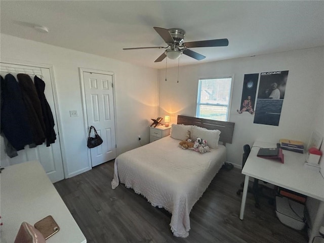 bedroom featuring a ceiling fan, dark wood-style flooring, and baseboards