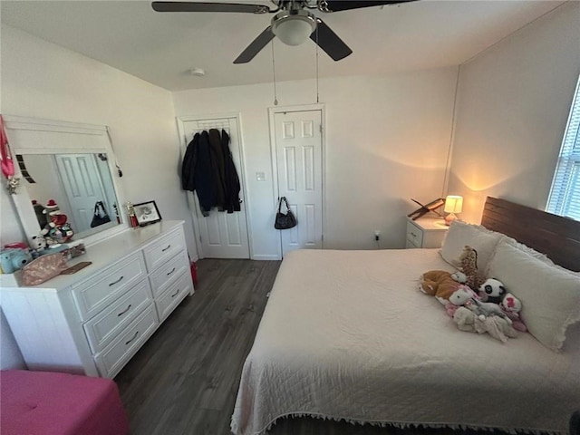 bedroom with dark wood-type flooring and ceiling fan