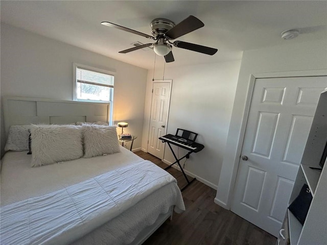 bedroom featuring ceiling fan, baseboards, and dark wood-type flooring