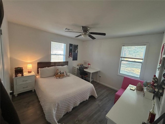 bedroom featuring dark wood-style floors, baseboards, visible vents, and a ceiling fan