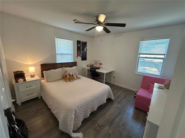 bedroom featuring ceiling fan, dark wood-style flooring, visible vents, and baseboards