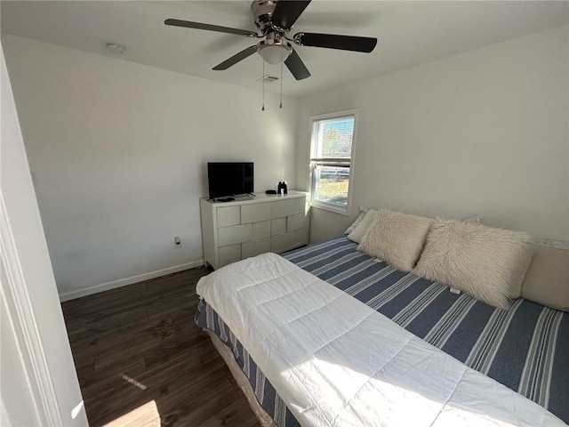 bedroom with ceiling fan, wood finished floors, and baseboards