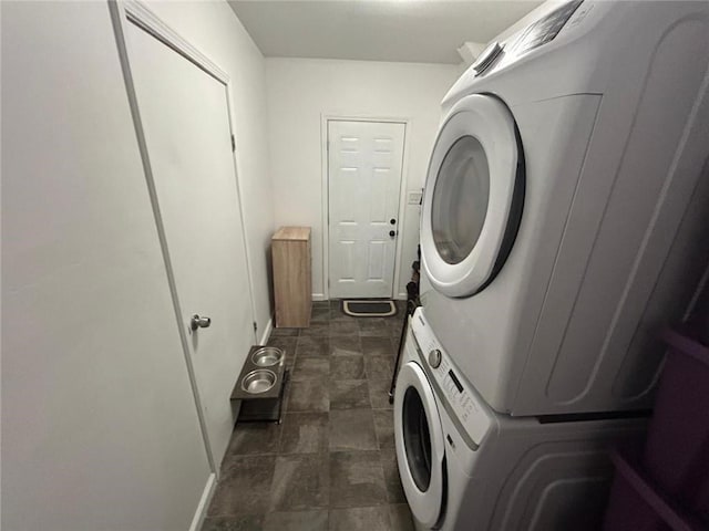 laundry area with laundry area and stacked washer / dryer