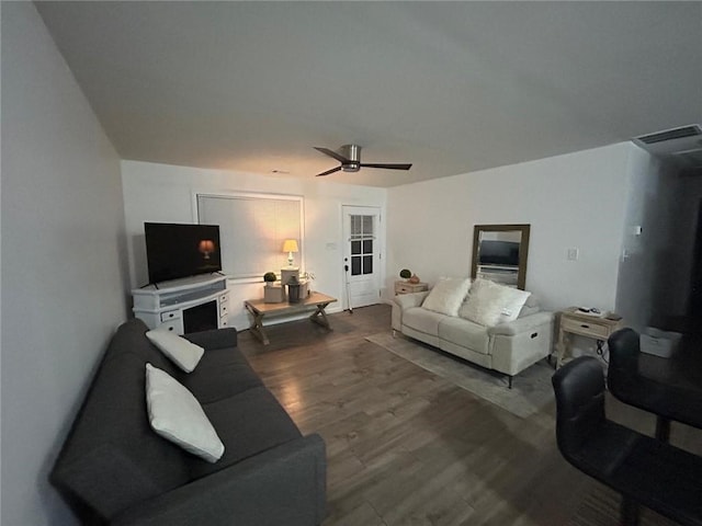 living room featuring ceiling fan, wood finished floors, and visible vents