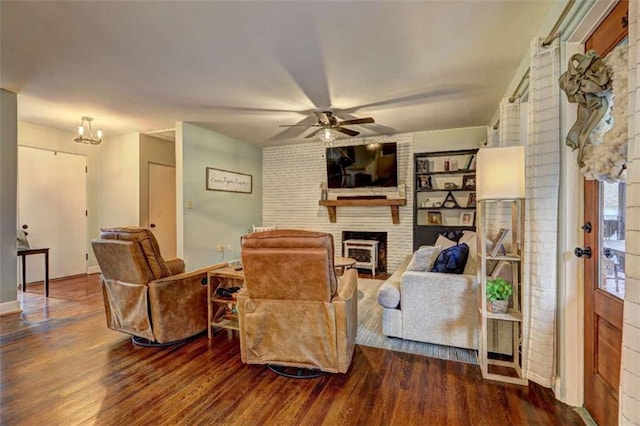 living room featuring a brick fireplace, hardwood / wood-style floors, and ceiling fan