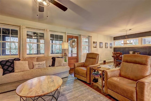 living room featuring wood-type flooring and ceiling fan