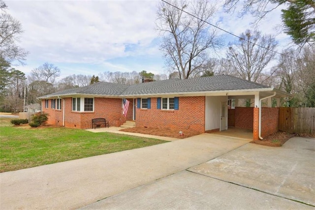 ranch-style home featuring a carport and a front lawn