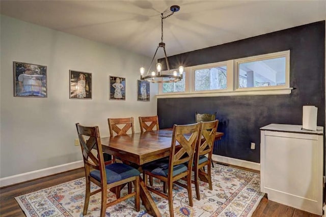 dining room featuring dark hardwood / wood-style floors and a chandelier