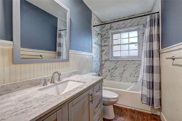 full bathroom featuring shower / tub combo, vanity, wood-type flooring, and toilet