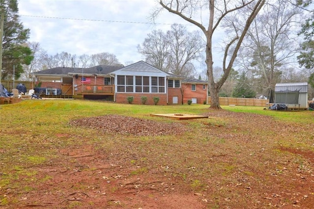 view of yard with a sunroom and a deck