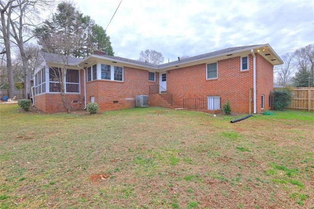 back of property with cooling unit, a lawn, and a sunroom