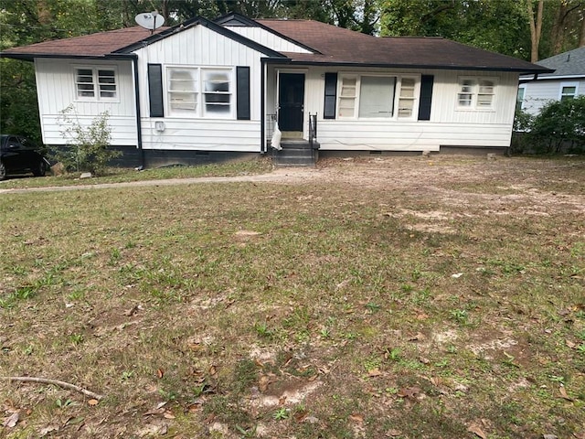 single story home featuring a front lawn