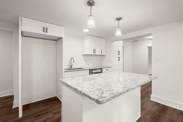 kitchen featuring white cabinets, dark hardwood / wood-style floors, light stone countertops, and sink