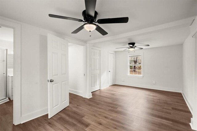 unfurnished bedroom with dark hardwood / wood-style floors and ceiling fan