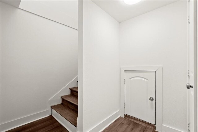 stairs featuring hardwood / wood-style flooring