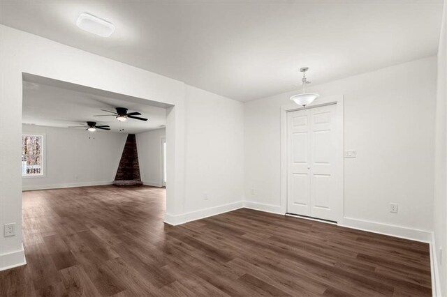 unfurnished room with ceiling fan and dark hardwood / wood-style flooring