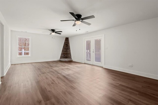 unfurnished living room with ceiling fan and hardwood / wood-style flooring