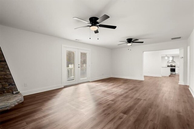 unfurnished living room with ceiling fan, dark hardwood / wood-style flooring, and french doors