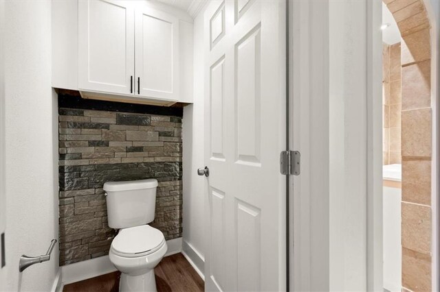 bathroom featuring toilet and hardwood / wood-style flooring