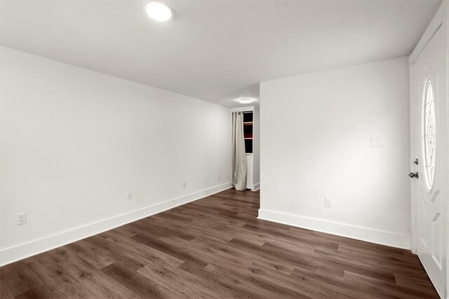 spare room with dark hardwood / wood-style floors