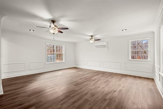 spare room featuring an AC wall unit, crown molding, ceiling fan, and dark hardwood / wood-style floors