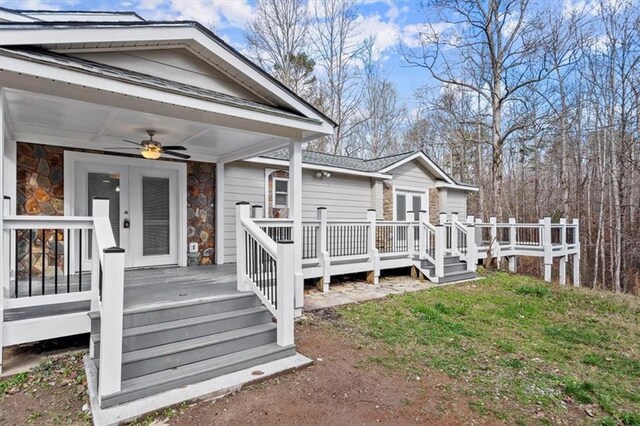 exterior space featuring a lawn and ceiling fan