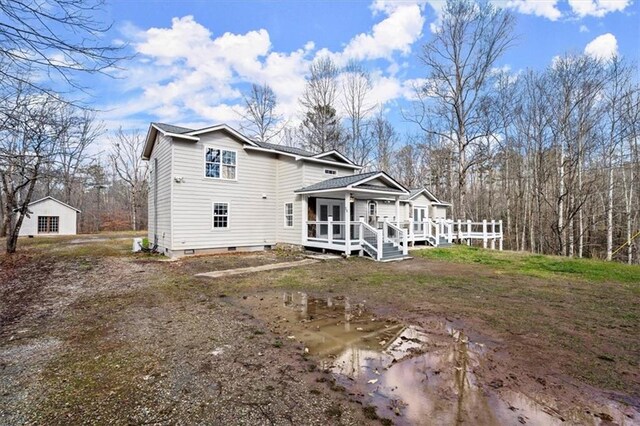 back of house with a wooden deck