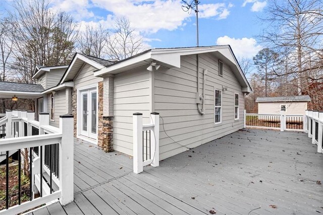 wooden terrace with a shed