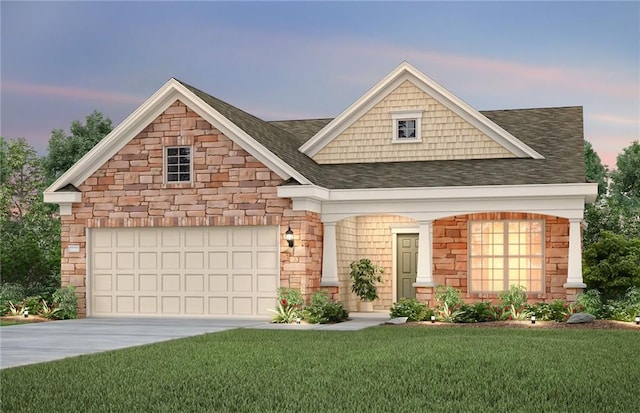 view of front of home with roof with shingles, a front lawn, driveway, stone siding, and an attached garage