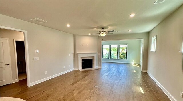 2808 Turnwater St, Hoschton, GA 30548 - unfurnished living room with a ceiling fan, wood finished floors, a fireplace, and recessed lighting