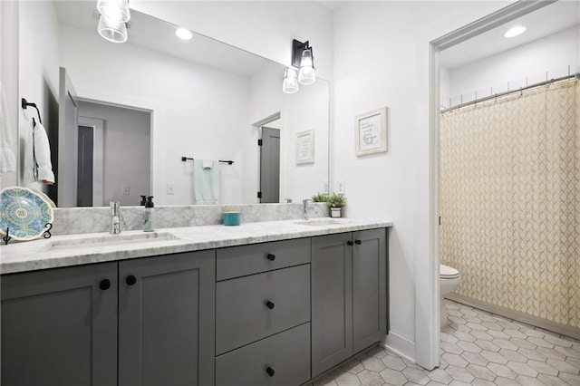 24 Becker Pl NW, Atlanta, GA 30307 - full bath with double vanity, toilet, baseboards, tile patterned flooring, and recessed lighting