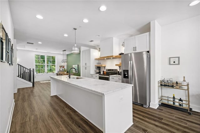 24 Becker Pl NW, Atlanta, GA 30307 - kitchen featuring appliances with stainless steel finishes, a sink, wall chimney range hood, recessed lighting, and an island with sink