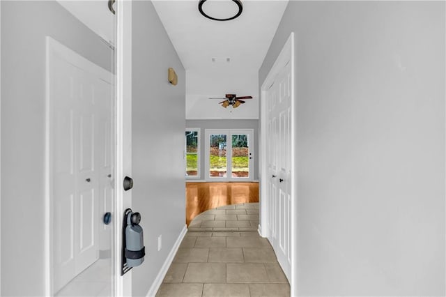 hall featuring light tile patterned floors