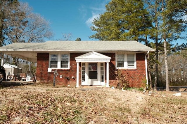 view of front of house featuring an attached carport and brick siding