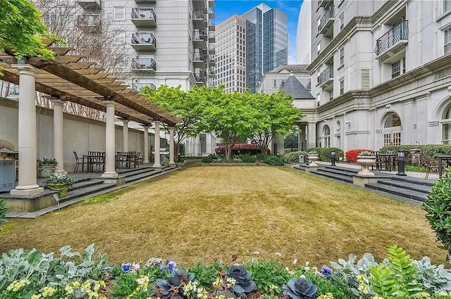 view of home's community with a yard and a pergola