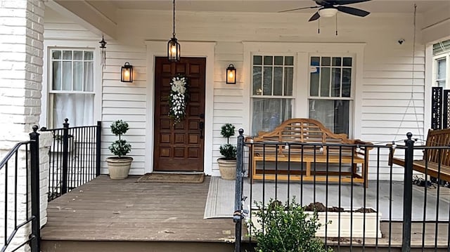 doorway to property with ceiling fan and covered porch