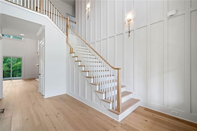 615 Claxton Ln, Milton, GA 30004 - staircase with hardwood / wood-style floors, a decorative wall, and a towering ceiling