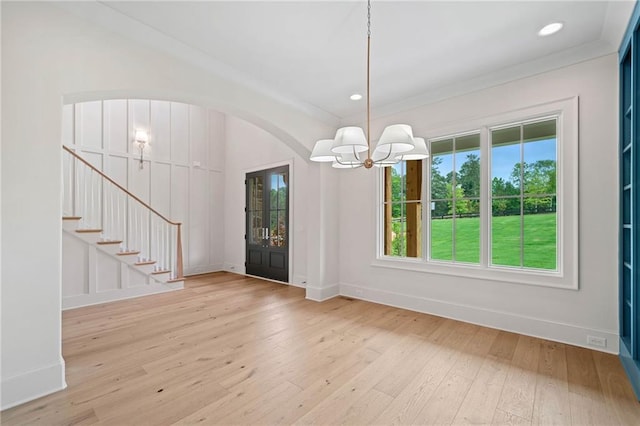 615 Claxton Ln, Milton, GA 30004 - foyer entrance featuring a chandelier, hardwood / wood-style flooring, baseboards, arched walkways, and stairs
