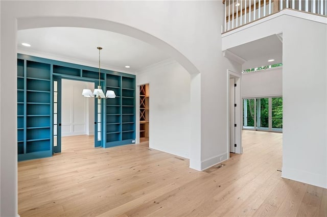 615 Claxton Ln, Milton, GA 30004 - unfurnished room with arched walkways, hardwood / wood-style flooring, a chandelier, baseboards, and crown molding