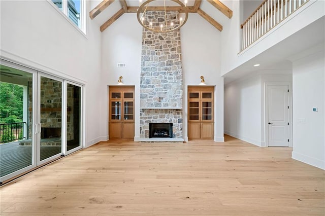 615 Claxton Ln, Milton, GA 30004 - unfurnished living room with high vaulted ceiling, wood finished floors, beam ceiling, a chandelier, and a fireplace