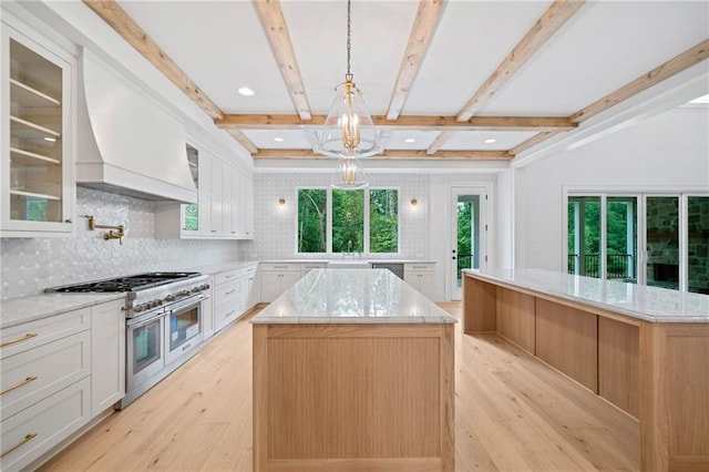 615 Claxton Ln, Milton, GA 30004 - kitchen with appliances with stainless steel finishes, a kitchen island, light wood finished floors, plenty of natural light, and beam ceiling