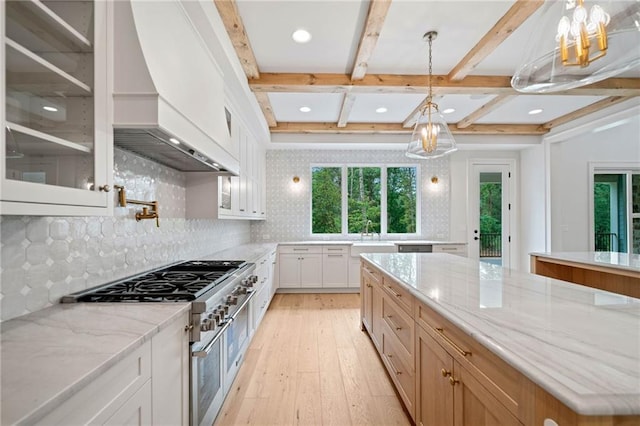 615 Claxton Ln, Milton, GA 30004 - kitchen with custom range hood, range with two ovens, light wood finished floors, glass insert cabinets, and light stone counters