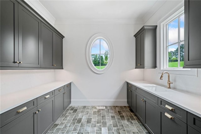 615 Claxton Ln, Milton, GA 30004 - laundry area featuring a sink, baseboards, and crown molding