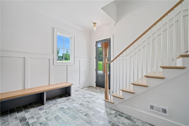 615 Claxton Ln, Milton, GA 30004 - foyer entrance featuring a decorative wall, stairs, and wainscoting